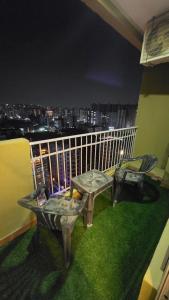 a balcony with a view of a city at night at Modern Studio With Balcony & Raod Facing View in Noida