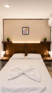 a white bed with a bow tie on it at Casa Wilson in Cartagena de Indias