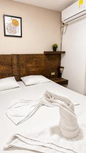 a white bed with a towel on it at Casa Wilson in Cartagena de Indias +13 photos