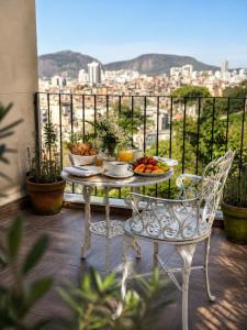 a table with a plate of fruit on a balcony at New Sugar Loft Apartments in Rio de Janeiro