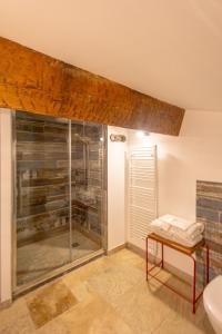 a bathroom with a glass shower and a sink at Mas Du Pont Rouge in Sylvéréal +24 photos