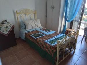 a bedroom with a bed with a wooden frame at L'ora d'aria in Bardi