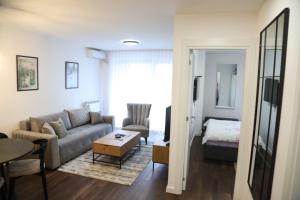 a living room with a couch and a table at I&I Tesla IV in Kragujevac +20 photos