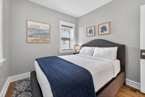 a bedroom with a large bed with a blue blanket at Your Chicago Retreat in Chicago