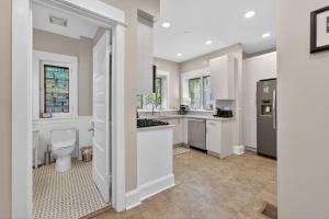 a large white kitchen with a toilet and a sink at Your Chicago Retreat in Chicago +46 photos