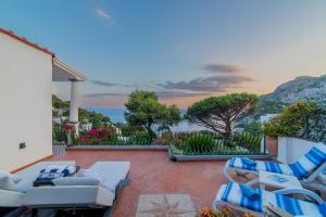 a patio with chairs and a view of the ocean at MARVELOUS CAPRI - Sea View Villa in Capri