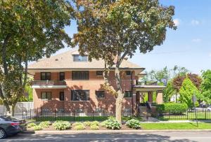 a brick house with a tree in front of it at Your Chicago Retreat in Chicago