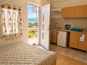 a kitchen with a door leading to a balcony at Apartments Maja in Star Dojran