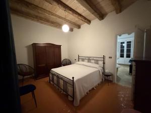 a bedroom with a bed and chairs in it at Casa Ela in Serra San Bruno