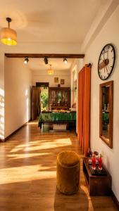 a room with a pool table and a clock on the wall at Greenland Villa Ella in Ella