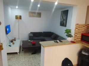 a living room with a couch and a table at Studio in La Goulette