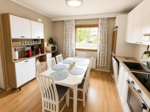 a kitchen with a table and chairs in a kitchen at Nordic City Home in Lahti