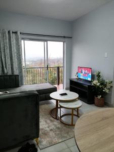 a living room with a couch and a table at Your Exclusive PMB Escape in Pietermaritzburg