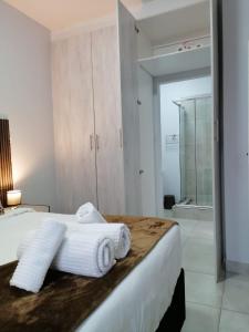 a bedroom with a bed with towels on it at Your Exclusive PMB Escape in Pietermaritzburg