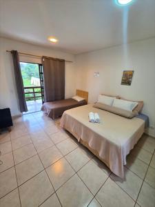 a bedroom with a large bed and a window at Park Golf Hostel Ipelandia in Foz do Iguaçu +26 photos