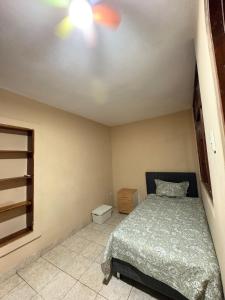 a bedroom with a bed and a ceiling fan at CIX HOUSE, Casa completa de 3 pisos in Chiclayo +7 photos