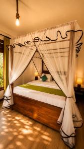a bedroom with a bed with a mosquito net at Greenland Villa Ella in Ella