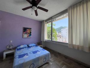 a bedroom with a bed and a large window at Tiki’s Penth in Acapulco +38 photos