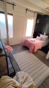 a bedroom with two beds and a mirror at Hostal Posada Lupinos in Punta Arenas