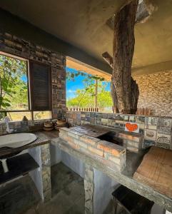 a large bathroom with a tree on the wall at Residencial dos Freitas in Jericoacoara