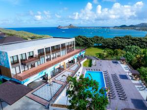 an aerial view of a building with the ocean in the background at Bluezone Club Residences by A'ila Resorts in Rodney Bay Village