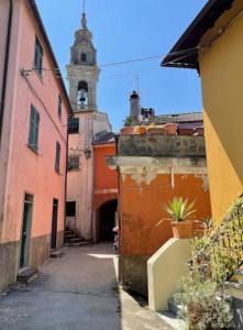 an alley with a clock tower in the background at Authentic and Charming apartments between Cinque Terre and Portofino - Velva House in Velva