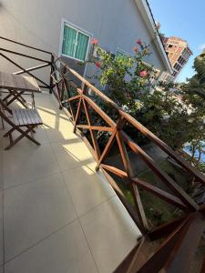 a balcony with a wooden railing and flowers on a building at Pousada Pérola do Mar in Tamandaré