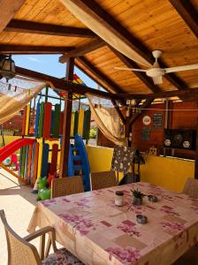 a table and chairs in a play room with a playground at Apartments Maja in Star Dojran