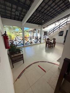 a room with a patio with a table and chairs at Pousada Pérola do Mar in Tamandaré