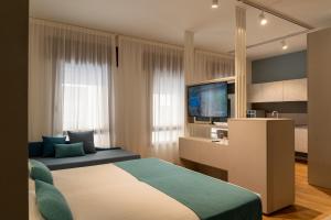 a bedroom with a bed and a flat screen tv at Hotel Vivit ***S in Mestre