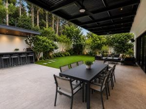 an outdoor patio with a table and chairs at סוויטת נווה in Pardes H̱anna