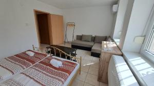 a living room with two beds and a couch at Mecseki Farkasvár in Magyarhertelend