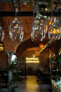 a restaurant with wine glasses hanging from the ceiling at Moment in Strzelce Opolskie