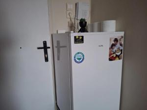 a white refrigerator with a picture on the side of it at Salamina Sea View in Kakí Vígla