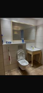 a small bathroom with a toilet and a sink at rahamni stays in Cheraga