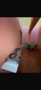 a kitchen with a stove and a table with chairs at rahamni stays in Cheraga