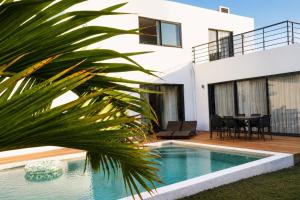 a villa with a swimming pool and a house at Villa Marea Private Pool in Grand Baie with garden, BBQ & Parking in Grand-Baie