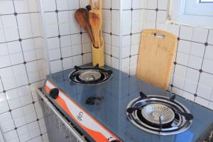 a small kitchen with a stove top in a wall at Soft stay homes in Mombasa
