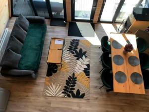 a living room with a couch and a table at Chalet Charme Bucovina in Coşna +11 photos