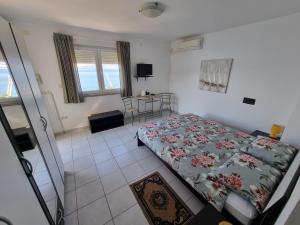 a bedroom with a bed and a table in it at Villa Kanata in Povile
