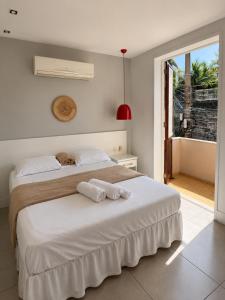a bedroom with a bed with two towels on it at New Sugar Loft Apartments in Rio de Janeiro