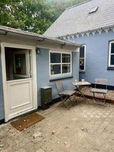 a blue house with a table and chairs in front of it at The Blue Country House in Nørre Broby