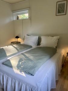 a large bed in a room with a window at The Blue Country House in Nørre Broby