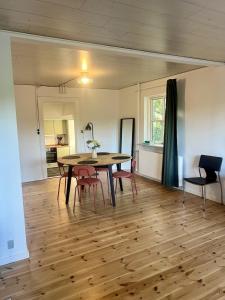a dining room with a table and red chairs at The Blue Country House in Nørre Broby
