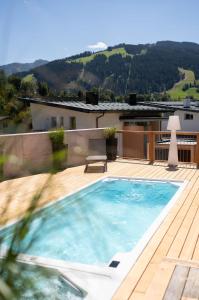 a swimming pool on the deck of a house at ALMMONTE LIGNUM - Premium Lodge in Wagrain
