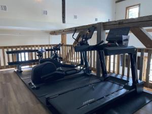 a gym with two exercise bikes on a treadmill at Luxury TownHome 106 in Wilmington