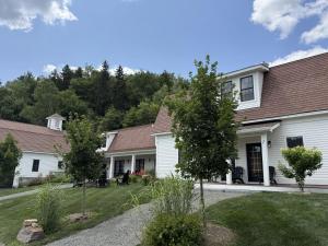 a white house with trees in the yard at Luxury TownHome 106 in Wilmington