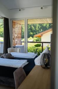 two beds in a room with a balcony at ALMMONTE LIGNUM - Premium Lodge in Wagrain
