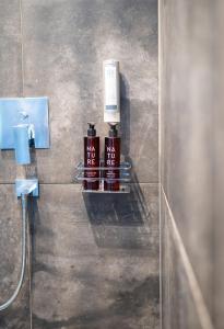 a bathroom with a shelf with bottles on a wall at ALMMONTE LIGNUM - Premium Lodge in Wagrain +31 photos