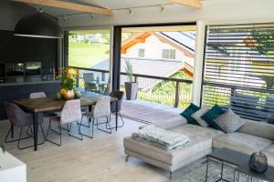 a living room with a couch and a table at ALMMONTE LIGNUM - Premium Lodge in Wagrain